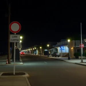 Empty streets of Myrtle Beach under curfew with signs indicating the hours.