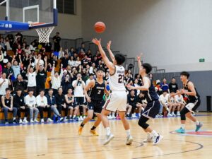 Action shot of a basketball game featuring players from Coastal Carolina University.