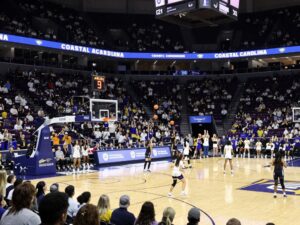 Fans cheering during a Coastal Carolina women's basketball game at HTC Center.
