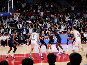 Players from Coastal Carolina basketball team in action at the HTC Center during a game.