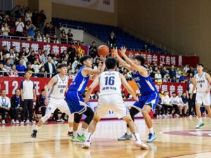 Collegiate basketball teams competing during a game.