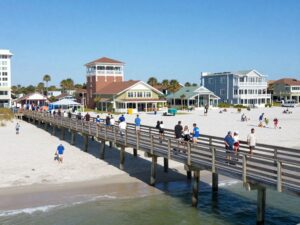 A view of the Surfside Beach pier with local businesses in the background
