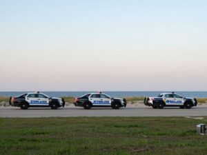 Myrtle Beach Police vehicles at a scenic beach location