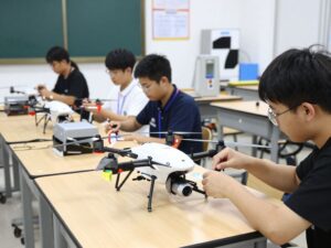 Students learning about unmanned aircraft systems in a classroom environment.
